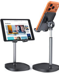 LISEN adjustable phone stand on desk holding smartphone, Nintendo Switch nearby