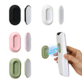 Four multicolor XYOFUN magnetic remote control holders mounted on a wall holding remotes