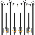 Four 10ft metal string light poles with fence brackets installed on a backyard patio