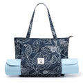 Leaf print canvas yoga bag showing shoulder strap, rolled yoga mat