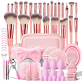 70 pink makeup brushes and tools laid out with a pink carrying case