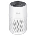 Levoit compact air purifier on a bedside table in a bedroom
