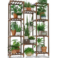 Bamworld tall wooden plant stand, three-tier shelving holding potted plants on a balcony