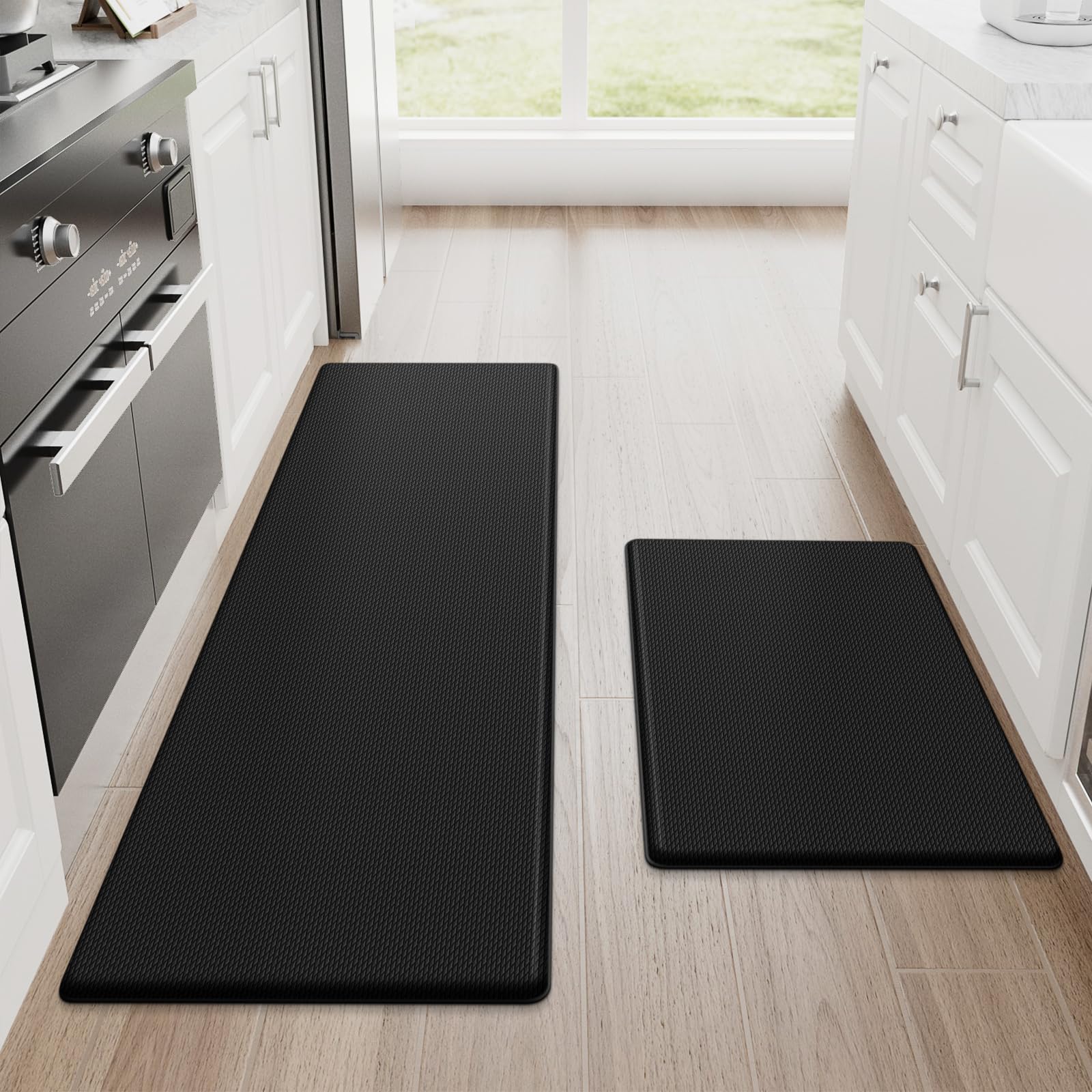 Black StepRite two-piece anti-fatigue kitchen mats on tile floor