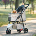 Khaki Carlson pet stroller with mesh canopy, swivel front wheel and reflective trim