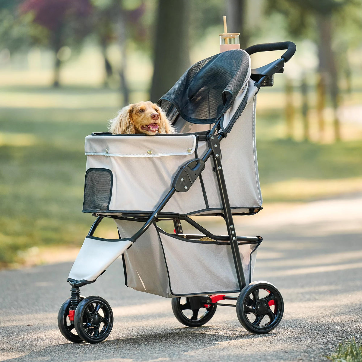 Khaki Carlson pet stroller with mesh canopy, swivel front wheel and reflective trim