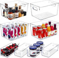 Eight clear plastic stackable storage bins in two sizes (four large, four small) on pantry shelf