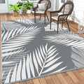 Grey white GENIMO 5'x8' waterproof outdoor patio rug on a deck