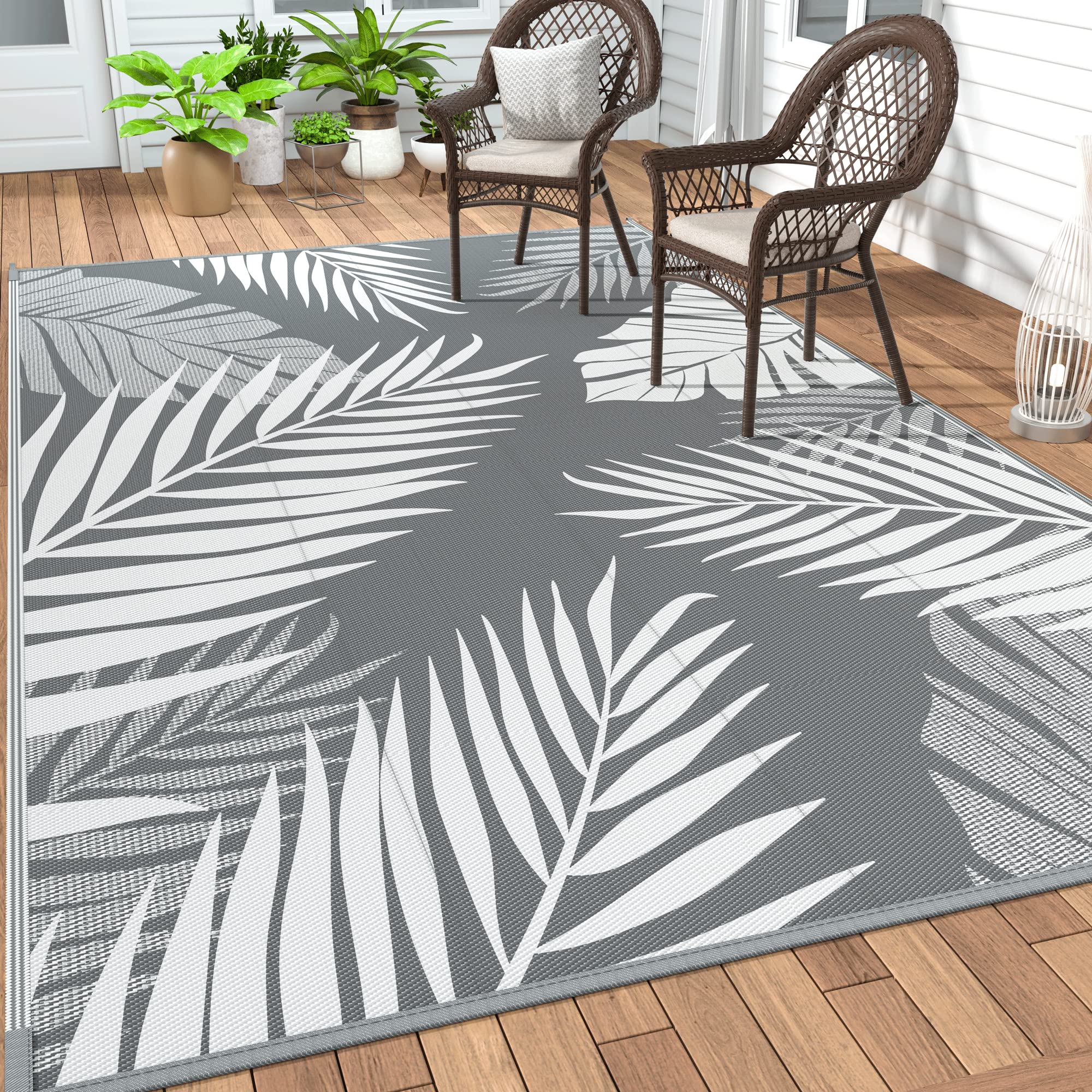 Grey white GENIMO 5'x8' waterproof outdoor patio rug on a deck
