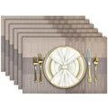 Aofmee woven vinyl placemats laid on a dining table, heat-resistant and washable