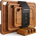 Deep-carbonized bamboo cutting boards displayed on wooden storage stand showing juice groove, easy-grip handles
